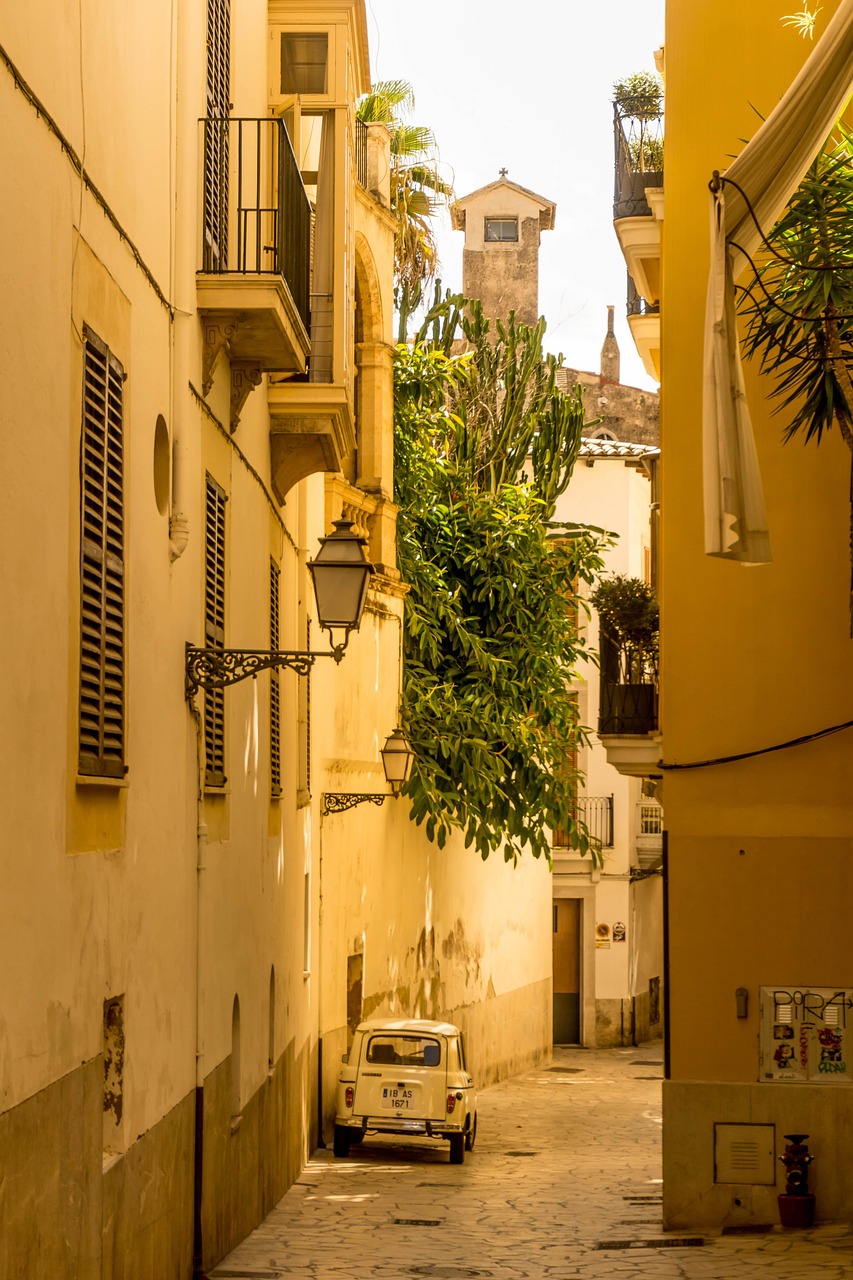 Original photo of a narrow sunlit old-town alley with warm ochre walls