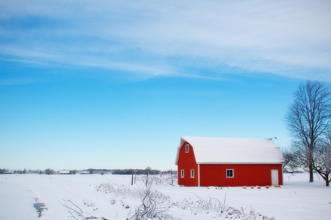 Original photo of a red barn in a snow-covered field under a wide winter sky