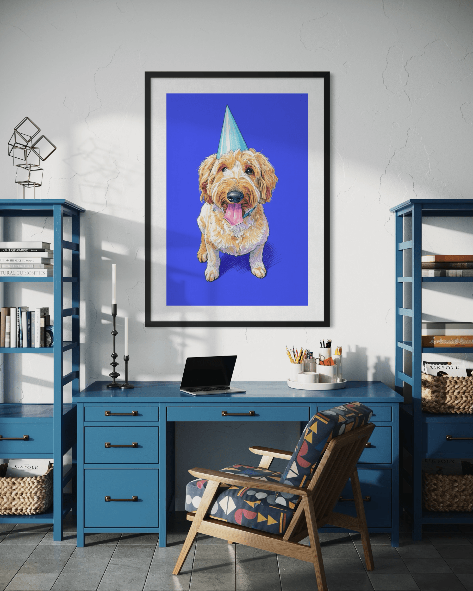 Framed pet portrait artwork hanging above a blue desk