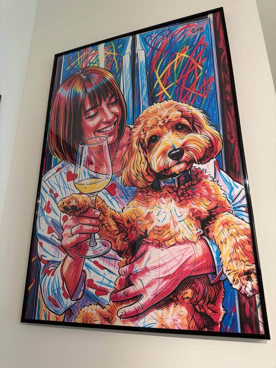 Printed pet portrait photo review hanging on a wall